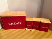 Bread box and three canisters with spoon grouped