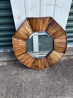 Front view showing octagonal mirror and bamboo slat frame
