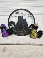 Group shot of wall sign and two fabric cat figurines
