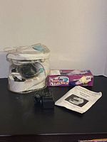 Overall lot with Sewing Genie machine in case, Mini Stitcher box, pedal, manual