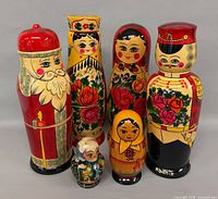 Front view of all four Rodnik bottle holders and two matryoshka dolls
