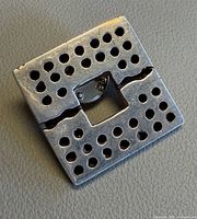 Front view showing perforated square sterling pin with central cut-out