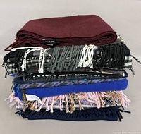 Stack of eight assorted scarves showing range of colours and patterns