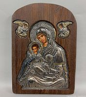 Front view of wooden plaque with silver icon
