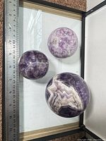 Three spheres with ruler for scale