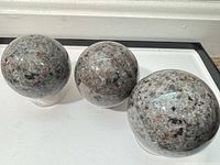 Three polished Yooperlite spheres on display stands