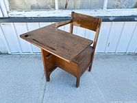 front angled view showing desktop, seat, pen groove, inkwell hole