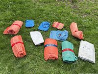 All tarps laid on grass showing quantity and colors