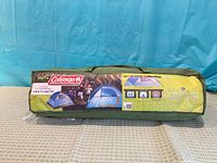 Green zippered carry bag with Coleman Youth tent label displayed