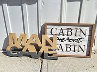 Front view of both decorative signs against wall