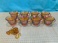 Eight carnival glass punch cups and hooks overview