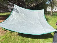 Full view of tent fabric stretched between poles showing colour and size