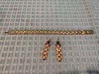 Bracelet laid flat with earrings below showing front detail