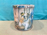 Front of cylindrical tin showing bulldog and football imagery