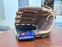 Side view of Rawlings brown leather baseball glove with tag