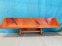 Front view of wooden shelf displaying full length and side curves