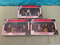 Front view of the three shrink-wrapped Star Wars Collector’s Case sets Series 1-3
