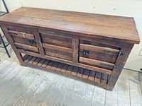 Front view of entire sideboard showing drawers, doors, and lower shelf