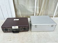 Front view of both hard cases side by side showing color, handles and latches