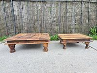 Both wooden platform tables side by side on pavement