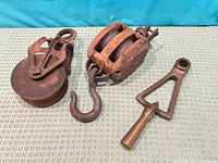 Overview of brass telegraph handle, single-sheave block, double-sheave block