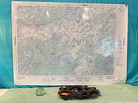 All three items together: map, boot spikes, paperweight