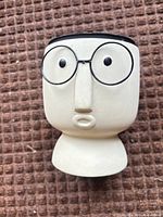 Front view showing face design and glasses