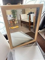 Full view of beige framed wall mirror front