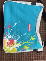 Front of teal Coleman lunch cooler with floral print
