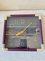 Front view of Deko square wall clock showing face and frame