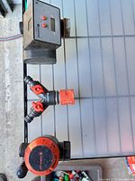 Three Gardena watering control devices laid out: electronic timer, splitter, mechanical timer