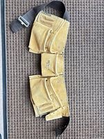 Full view of suede leather tool belt showing pockets, hammer loop and adjustable web belt