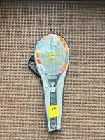 Full view of packaged electric bug zapper racket inside clear sleeve