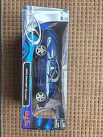 Front view of boxed 1:18 blue Corvette model