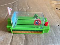 Overall view of slot racer showing base, dome, tokens, button, flag