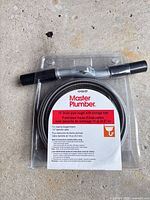 Front view of sealed Master Plumber drain auger package