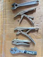 Group shot showing two adjustable wrenches and three locking pliers