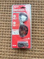 Front view of sealed package showing safety glasses, gasket, and soft case