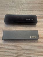 Two Parker branded cases, closed