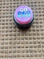Top view showing pink button face and printed phrase