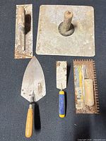 All five tools laid out on dark surface