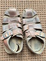 Top view of both sandals showing overall design, color and wear