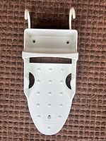 Front view showing overall shape, hooks and perforations