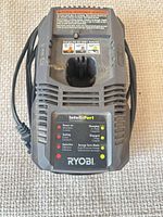 Front view of Ryobi IntelliPort charger showing LED indicator panel and battery slot