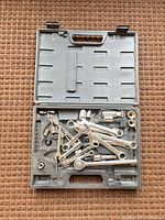 open plastic case showing full set of wrenches, sockets and accessories