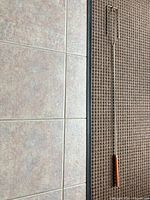 Full view of rotisserie spit rod showing length and handle