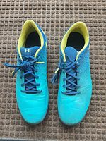 Top view of both cleats showing color, laces, and interior lining