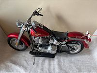 Full side view of large red Harley-Davidson model motorcycle