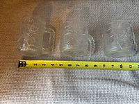 All three frosted embossed glass mugs with tape measure showing approximately 3 inch height