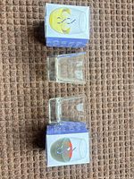 Two clear square wine glasses with boxes